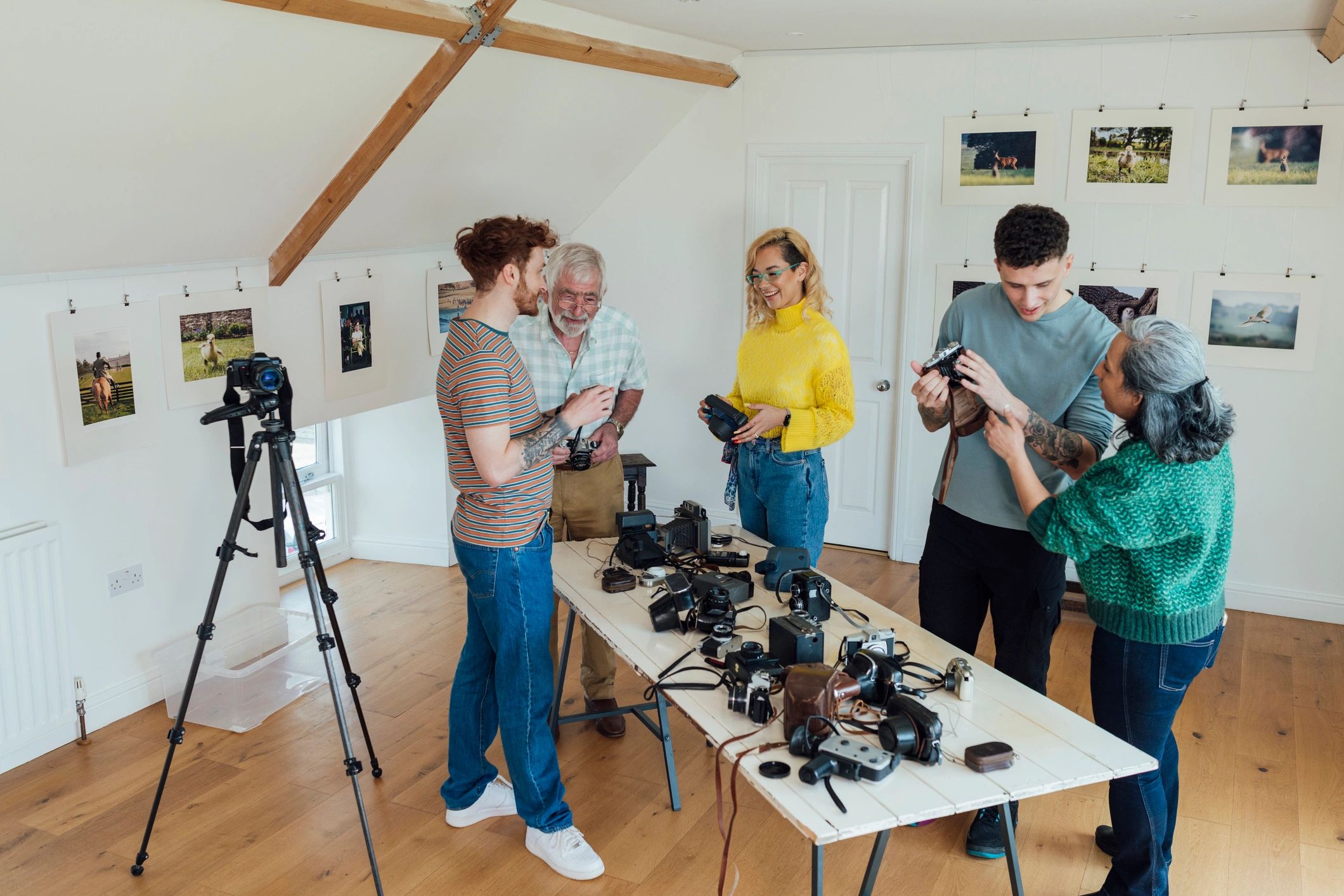 Creative team discussing cameras in a gallery setting