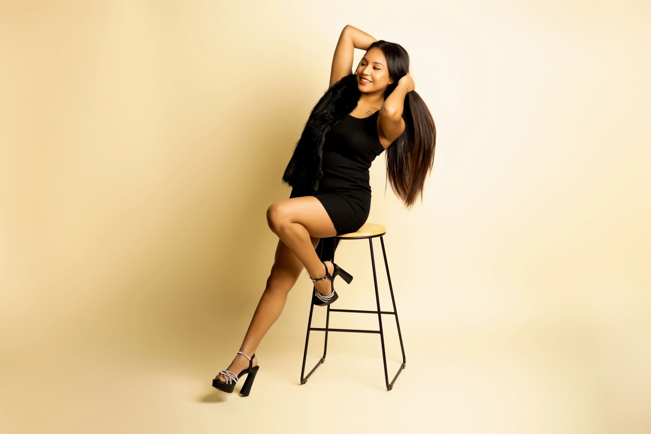 Woman in a black dress posed in a contemporary editorial style