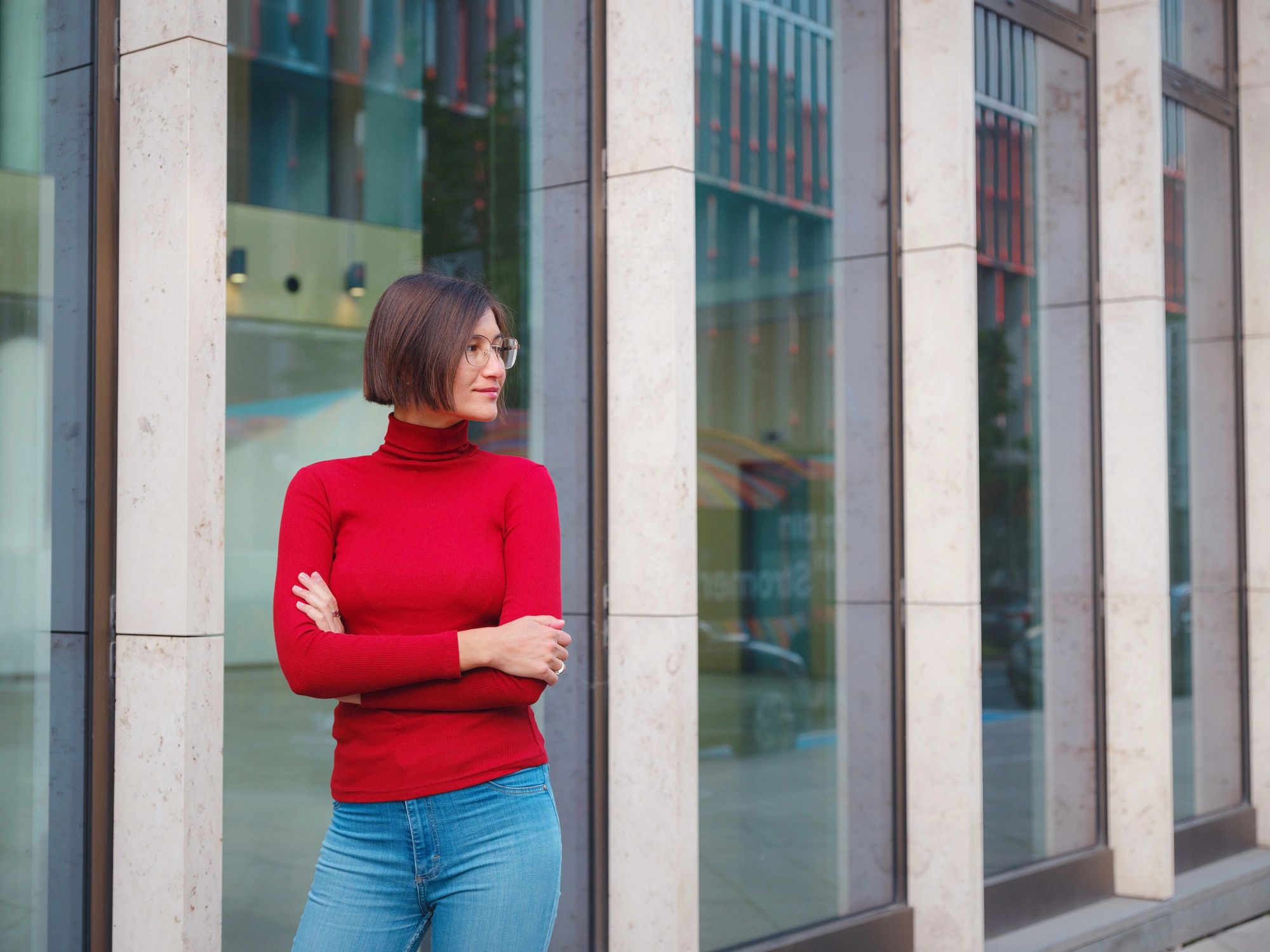Stylish woman framed by modern architecture