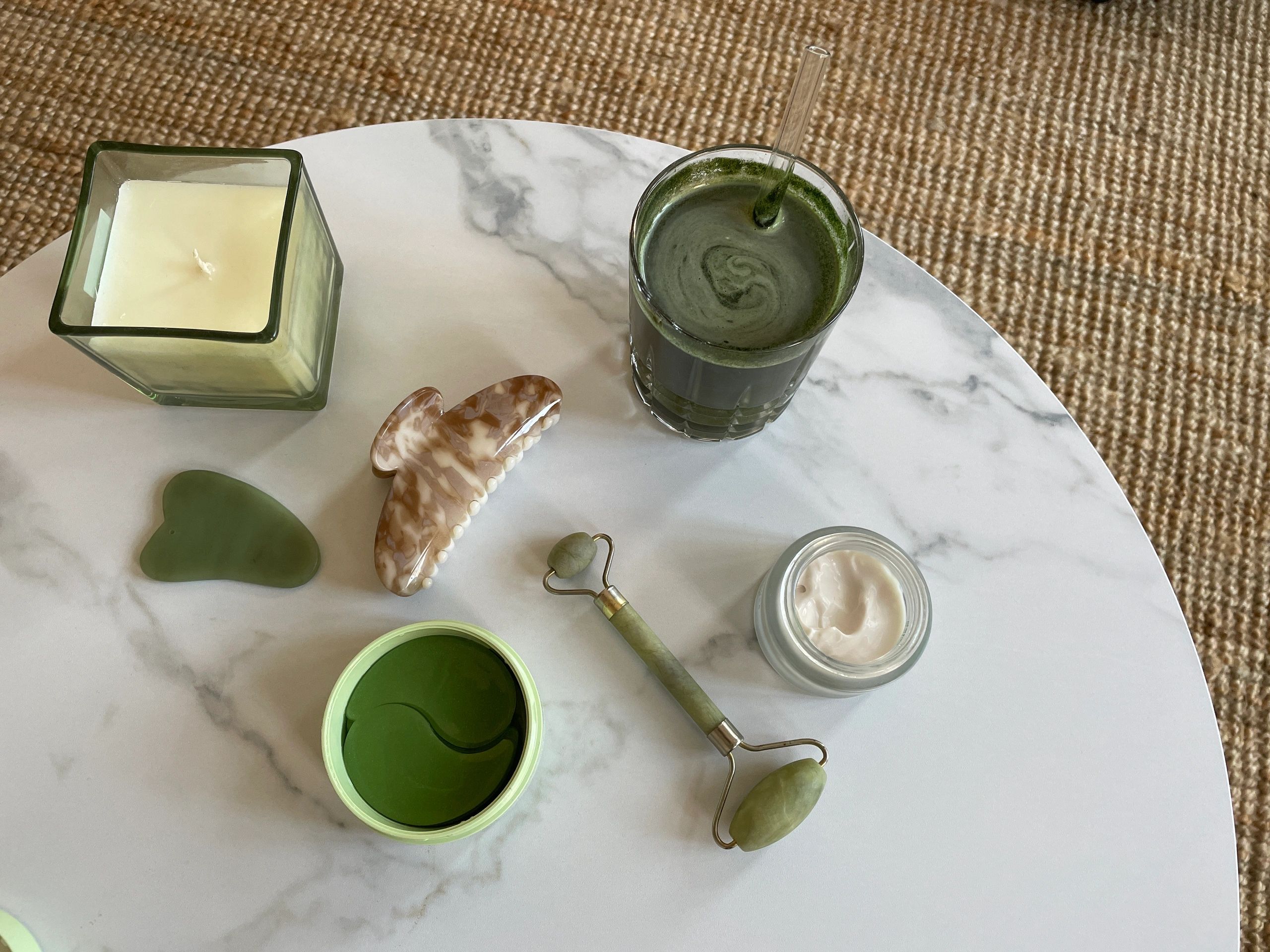 Skincare and wellness tools arranged on marble