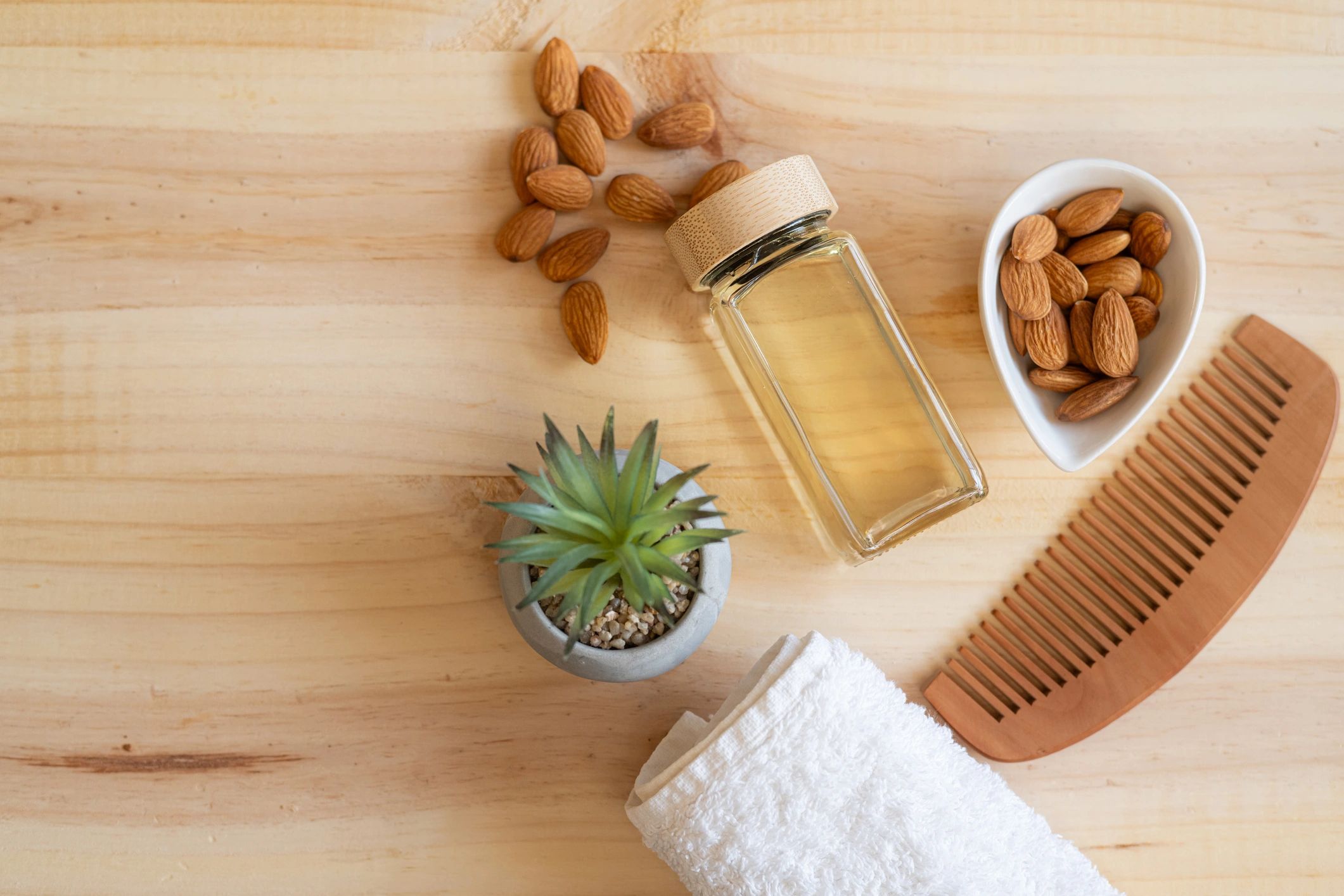 Natural wellness and hair care products on a wooden table
