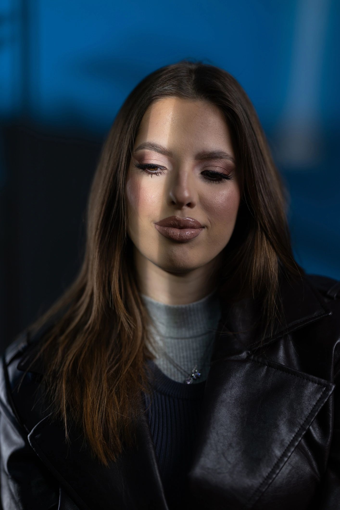 Moody studio portrait of a woman in leather jacket